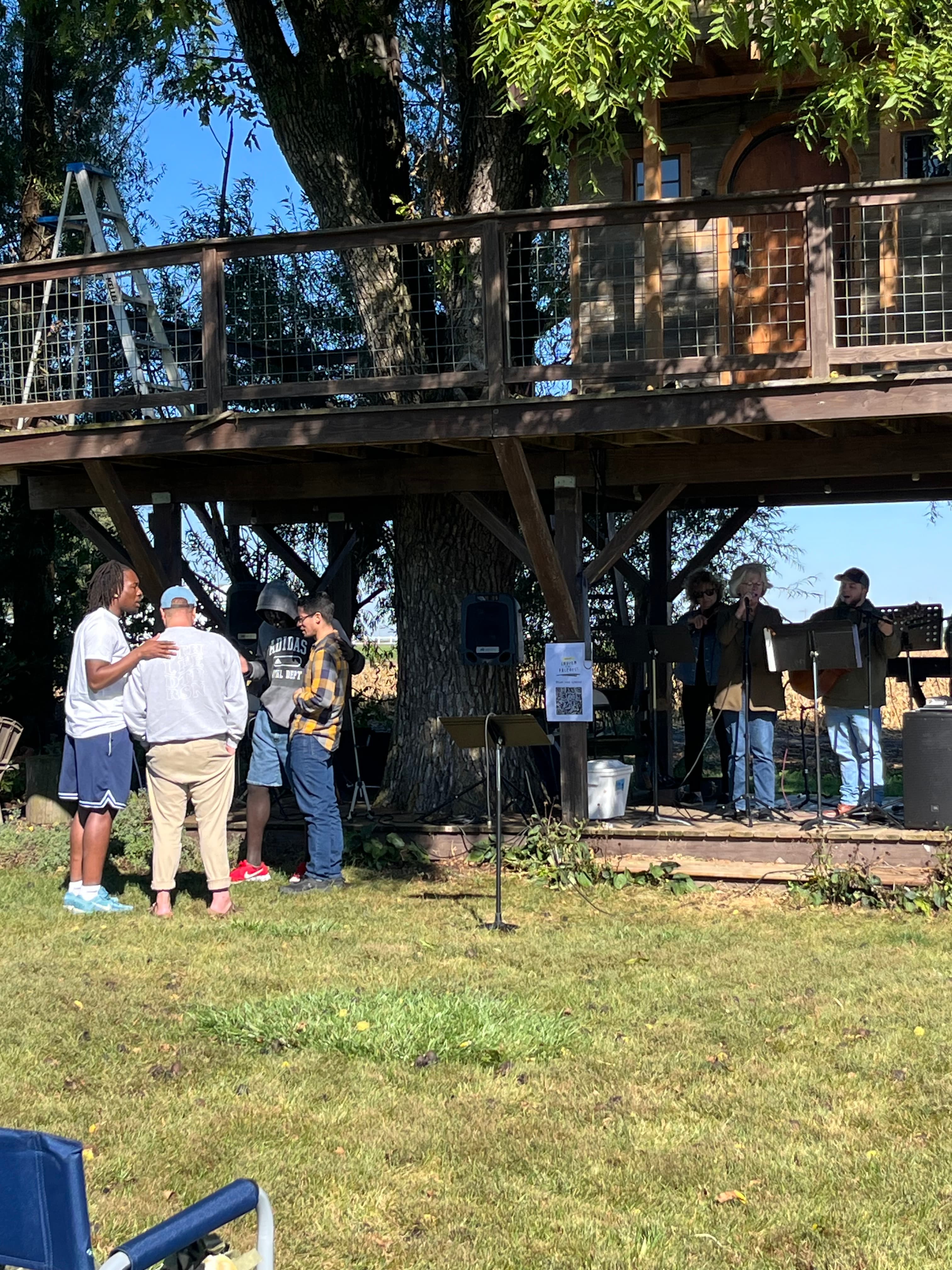Pastors and friends gathered after an outdoor service.