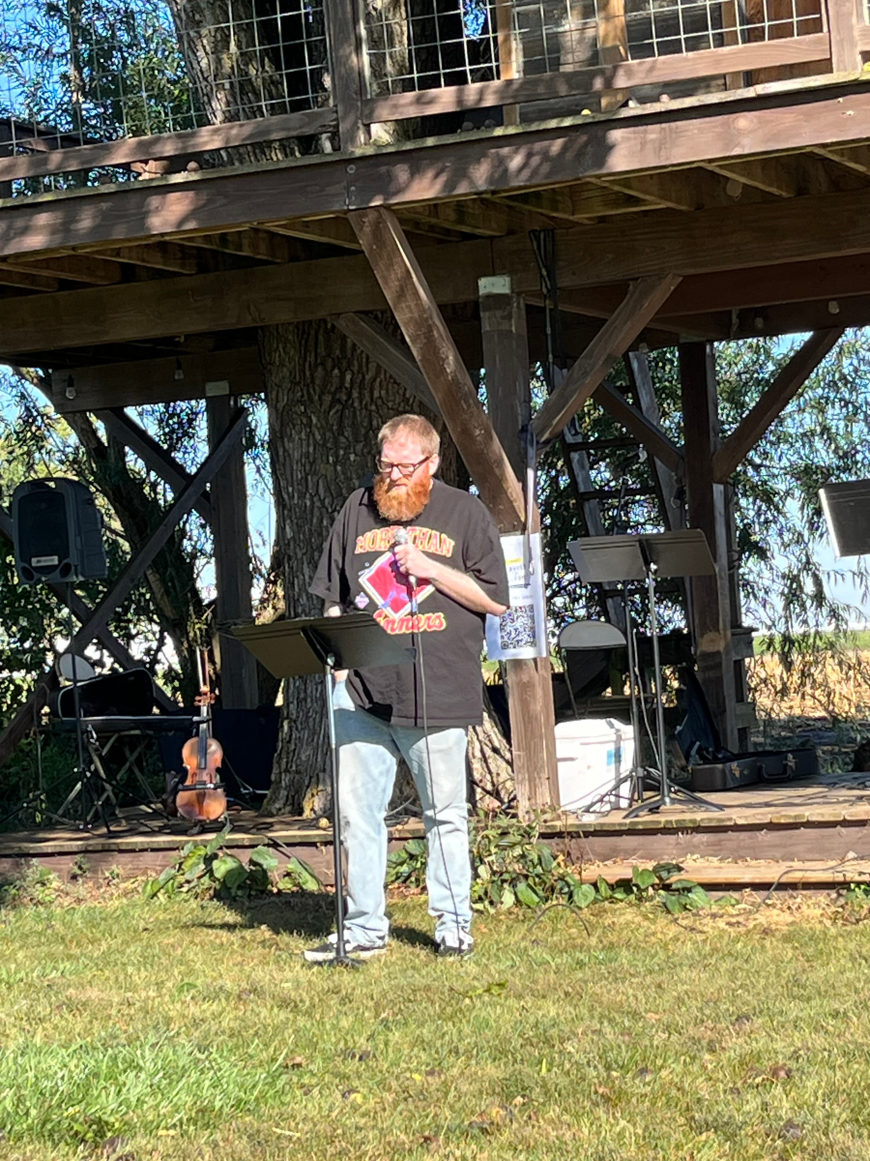 A pastor preaching at an outdoor Church For Pastors gathering.